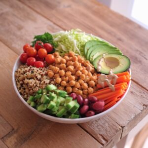 Topping Rainbow Buddha Bowl with Seeds and Fresh Cilantro